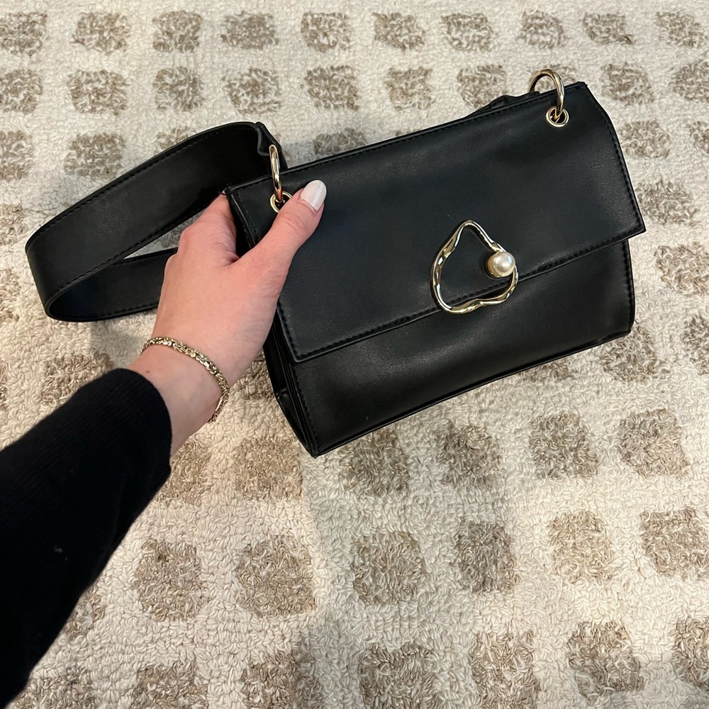 Elegant Black Handbag with Gold and Pearl Accents